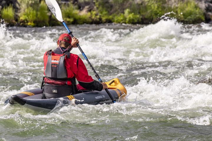Daredevil in red gear expertly paddles the rapids with the McKenzie 105.