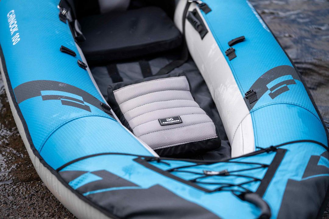 Saddle Seat: Blue and gray inflatable kayak ideal for kids by the shore.