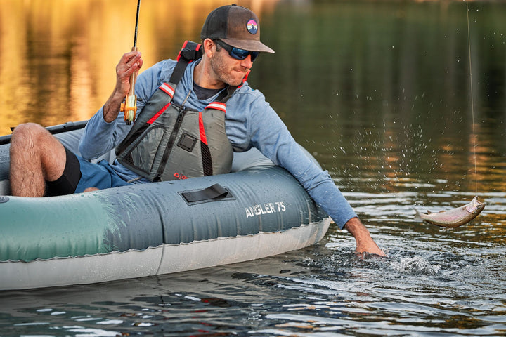 Backwoods Angler 75 helps solo kayaker catch fish on calm lake.