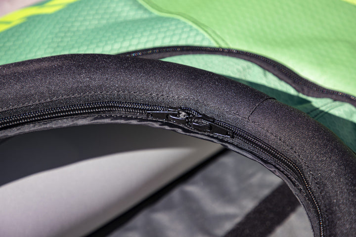 Close-up of a zipper on a Navarro 145 touring deck cover, green and black fabric.