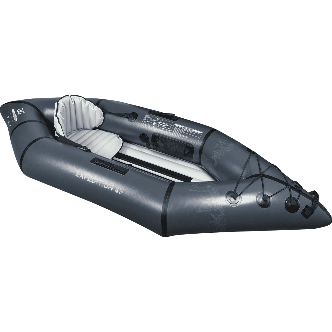 Backwoods Expedition 85: gray inflatable kayak with paddles, seats, and rope fastenings.